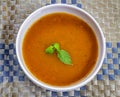 Thick creamy tomato soup served hot in a soup bowl. Hot tomato soup in a bowl