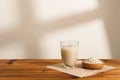 A thick cup of rice water and a wooden plate of raw rice are placed on the table.  Elements of life ingredients. Royalty Free Stock Photo