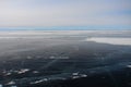 Thick dark blue ice of mountain lake in winter