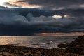 Thick dark thunderclouds above the sea