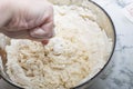 Thick dough is manually mixed