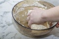 Thick dough is manually mixed