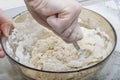 Thick dough is manually mixed with spoon