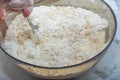 Thick dough is manually mixed with spoon
