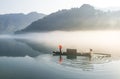 Thick fog on the lake, boats, wetlands