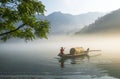 Thick fog on the lake, boats, wetlands