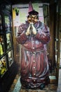 Thick Friar at the door of a restaurant, vintage doll claim traditional food