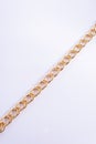 Thick gold chain on a white background, top view