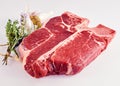 Thick juicy raw porterhouse steak with herbs Royalty Free Stock Photo