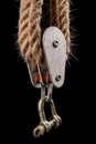 Thick jute rope wrapped on rollers in a sailing pulley. Accessories used on yachts for sailing in the sea Royalty Free Stock Photo