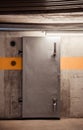 Thick metal hermetic door enter into nuclear fallout shelter built in basement