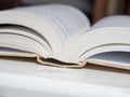 A thick open book lies on a white background. The concept of learning and knowledge Royalty Free Stock Photo