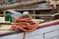 Thick orange rope on the rail of an old wooden fishing boat Royalty Free Stock Photo