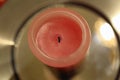 Half-Burned Thick Pink and Red Wax Candle in a Closeup Royalty Free Stock Photo
