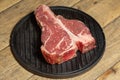 Thick Raw T-Bone Steak with Seasoning and Rosemary Royalty Free Stock Photo