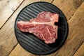 Thick Raw T-Bone Steak with Seasoning and Rosemary Royalty Free Stock Photo