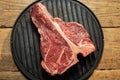 Thick Raw T-Bone Steak with Seasoning and Rosemary Royalty Free Stock Photo