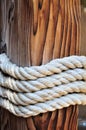 Thick rope around a wooden mooring bollard, Croatia Royalty Free Stock Photo