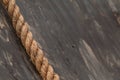 Thick Rope Lies Against Wooden Wall At Extreme Obstacle Course