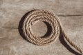 Thick rope on old wooden background. Top view. Copy, empty space for text Royalty Free Stock Photo