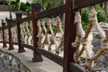 Thick rope ropes, intertwined crosswise, hang on wooden railings, decorative fence along the alley in the Park for recreation. Royalty Free Stock Photo