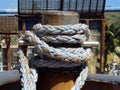 Thick rope tied around a steel bollard Royalty Free Stock Photo