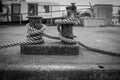 a thick rope is wound on a bollard in the harbor Royalty Free Stock Photo