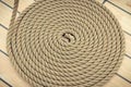 Thick rope wrapped in spiral on deck of ship