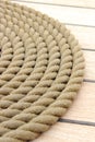 Thick rope wrapped in spiral lying on deck of ship