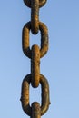 Thick rusty chain on a blue sky background Royalty Free Stock Photo