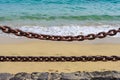 Thick rusty chains with the sea in the background Royalty Free Stock Photo