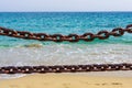 Thick rusty chains with the sea in the background Royalty Free Stock Photo