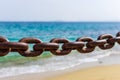 Thick rusty chains with the sea in the background Royalty Free Stock Photo