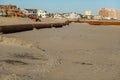 Thick rusty pipeline on a sandy beach forming a right angle Royalty Free Stock Photo