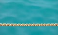 Thick ship rope on the sea water background Royalty Free Stock Photo