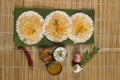 Thick spongy dosas served together with coconut chutney and sambhar