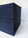 A thick stack of plain blue paper for book binding material in a room Royalty Free Stock Photo