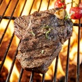 Thick succulent lean rump steak grilling on a fire Royalty Free Stock Photo