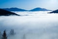 Thick white fog among mountain peaks Royalty Free Stock Photo