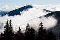 Thick white fog among mountain peaks Royalty Free Stock Photo