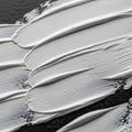 Thick white paint is applied in broad, textured strokes over a dark surface. The layers Royalty Free Stock Photo