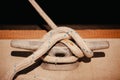 Thick white ropewrapped around metalbolt on concrete floor Royalty Free Stock Photo