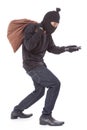 Thief with bag and holding flashlight Royalty Free Stock Photo