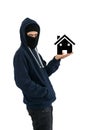 Thief with balaclava isolated on white background with an house into his hands Royalty Free Stock Photo