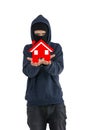 Thief with balaclava isolated on white background with an house into his hands Royalty Free Stock Photo