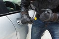 Thief breaking into car with screwdriver Royalty Free Stock Photo