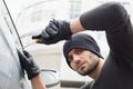 Thief breaking into car with screwdriver Royalty Free Stock Photo