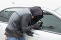 Thief breaking into car with screwdriver Royalty Free Stock Photo