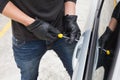 Thief breaking into car with screwdriver Royalty Free Stock Photo