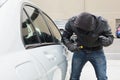 Thief breaking into car with screwdriver Royalty Free Stock Photo